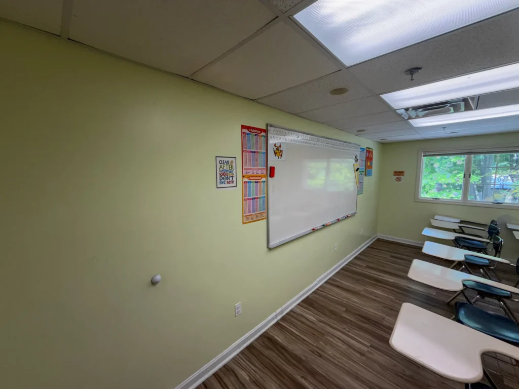 Bright remodeled classroom with wood-look flooring and a whiteboard