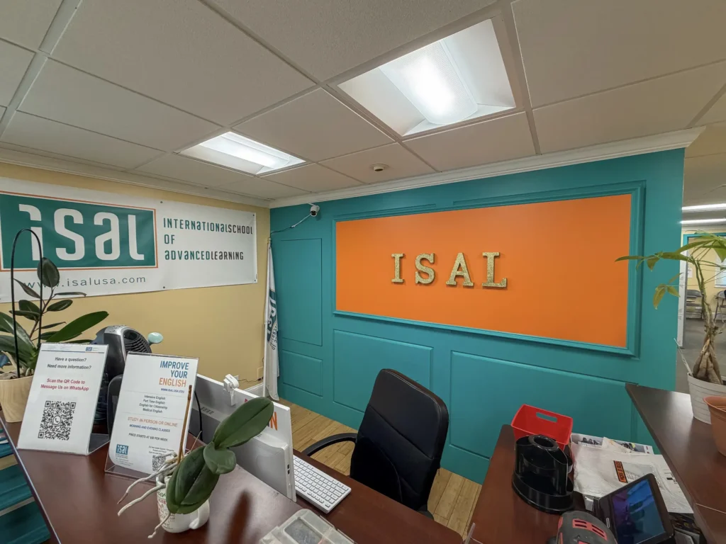 Commercial reception desk with teal walls and an orange accent panel