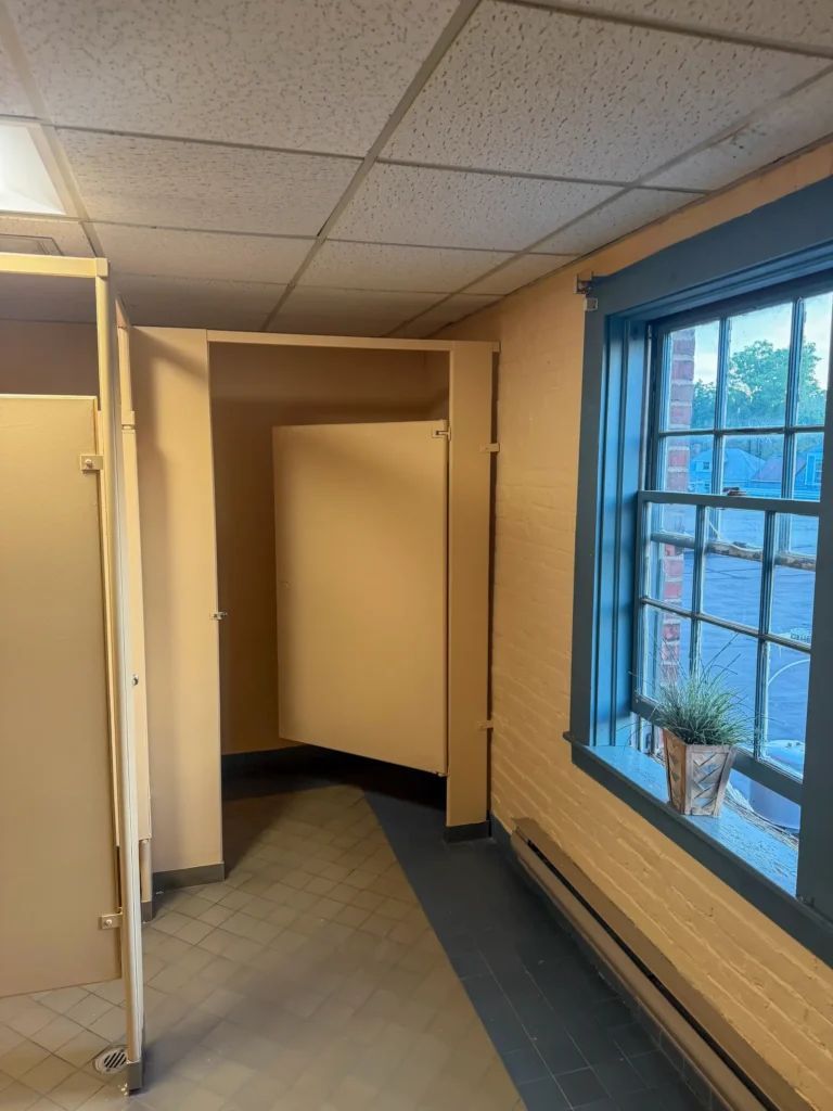 Interior room with built-in storage and a dark-trimmed window during renovation